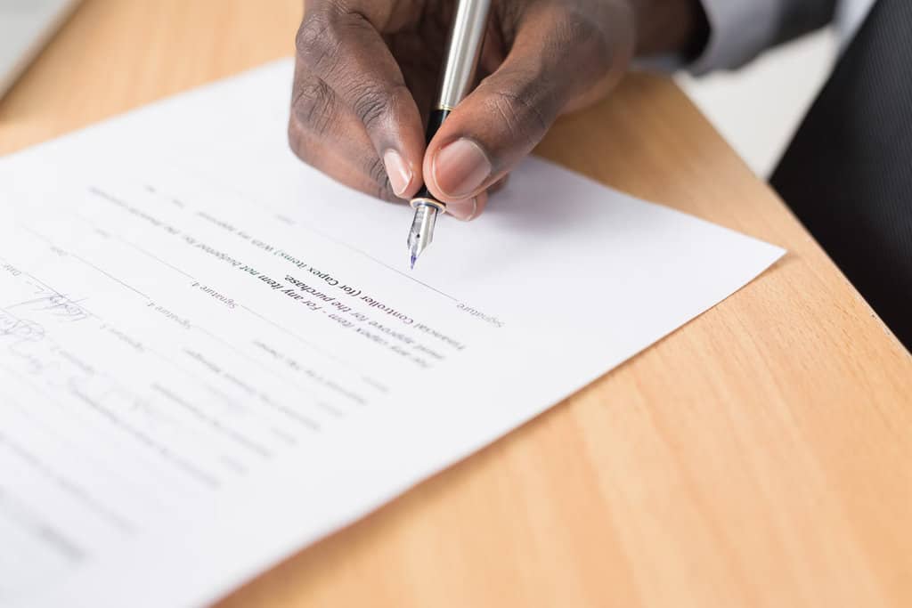 Authorized person signing a real estate contract or agreement at Harrison Homesales.
