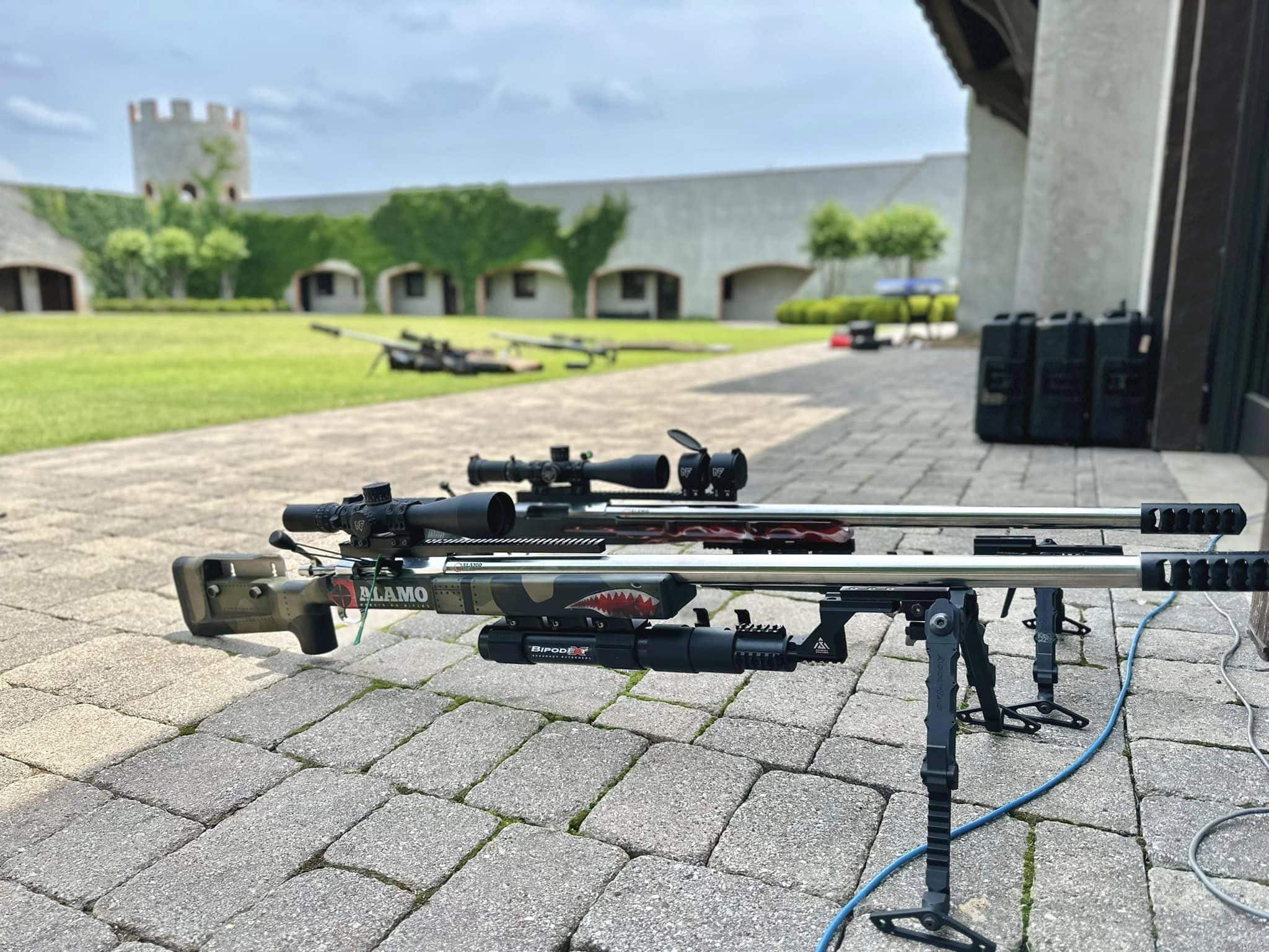 Two beautiful rifles built by Alamo Precision showcasing the Accuacy Solutions BipodeXt rifle stabilizer