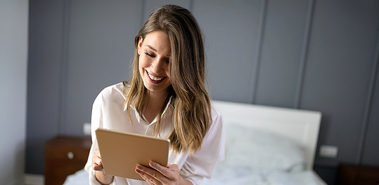 Sexy single woman seeking men in Croydon checking her tablet