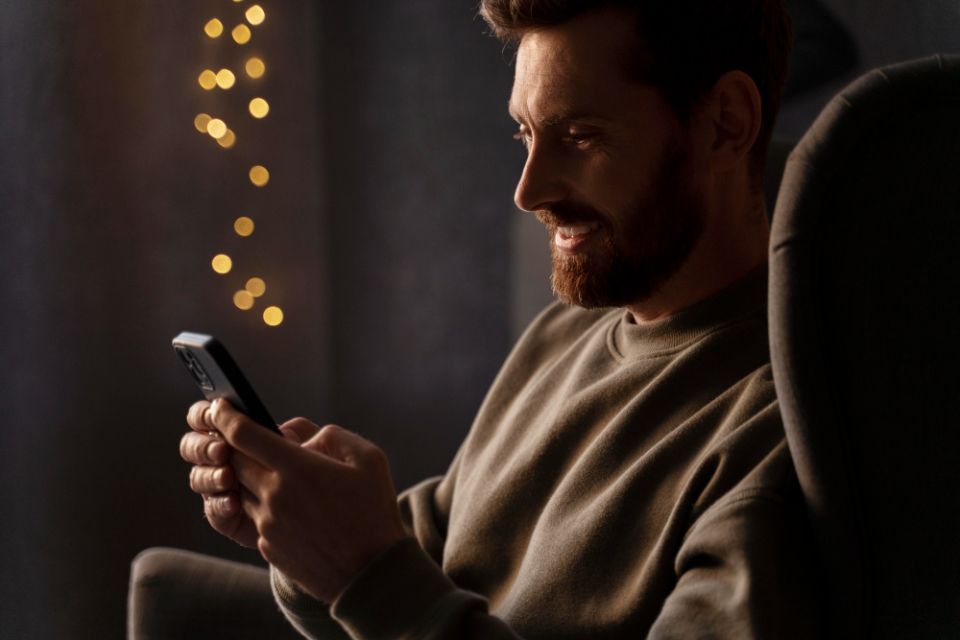 Man staring at phone, meanining navigating on Together2Night