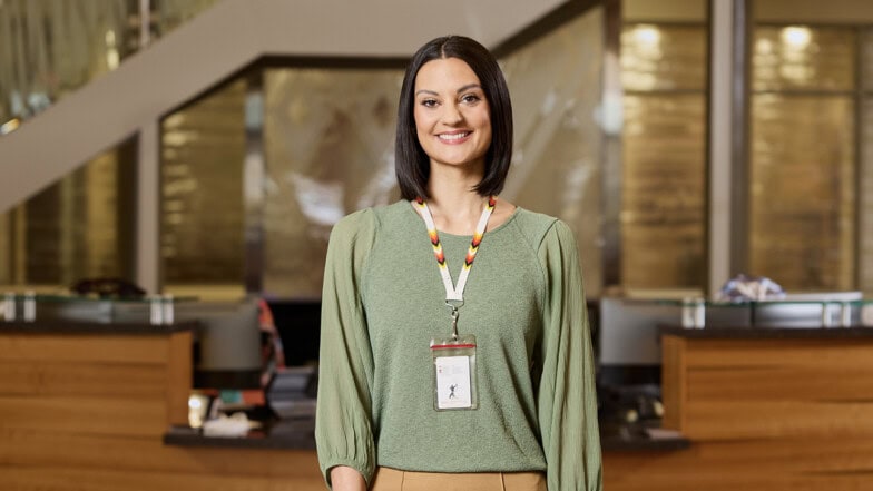 An associate smiling at a front desk.