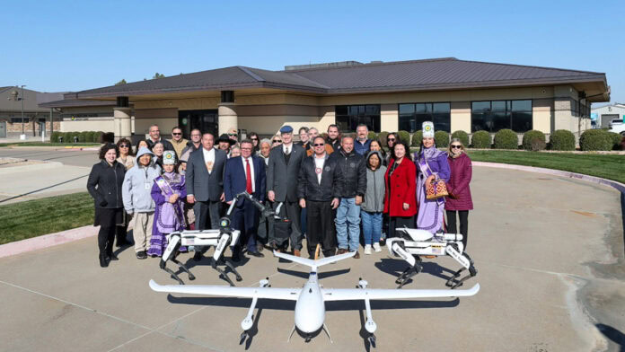 Community leaders gathered around a drone.