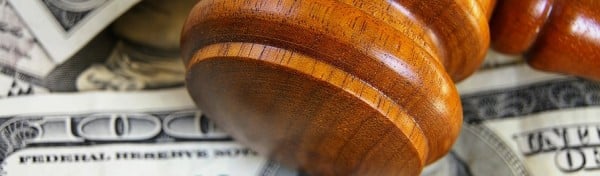 Closeup of a gavel on cash, from above