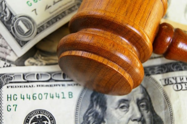 Closeup of a gavel on cash, from above