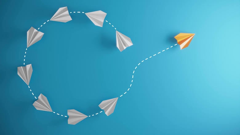 Paper airplanes forming a circular pattern representing debt relief and financial freedom.