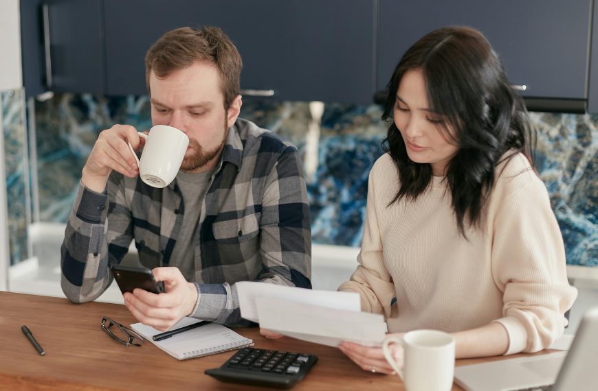 Unlicensed financial advisors discussing debt relief strategies at a modern office.