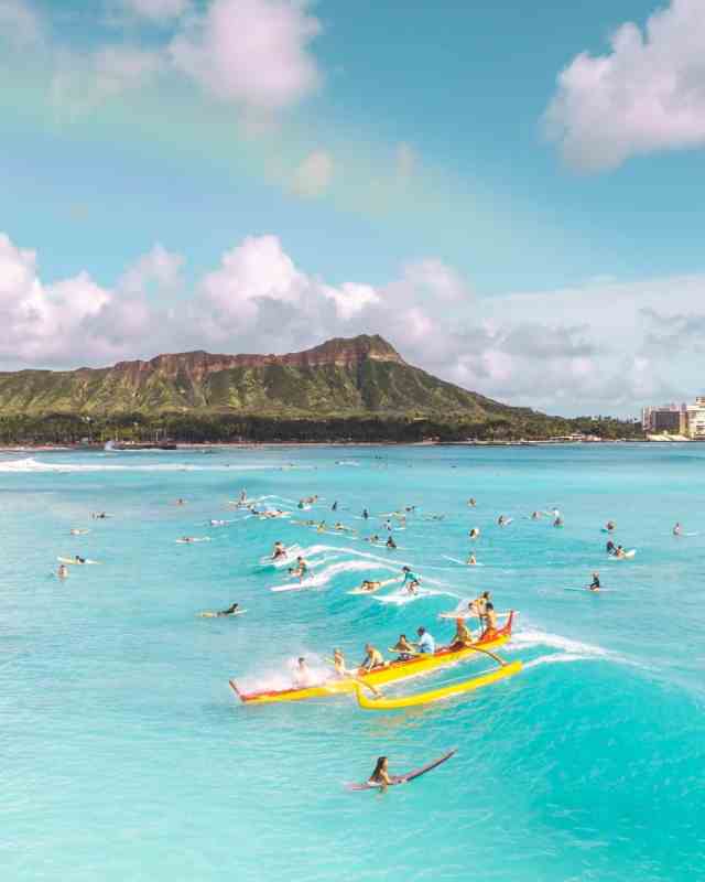 people riding yellow kayak on sea