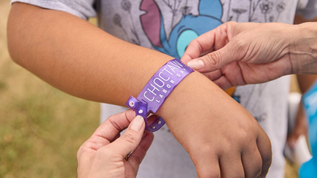 Putting a wristband on a child