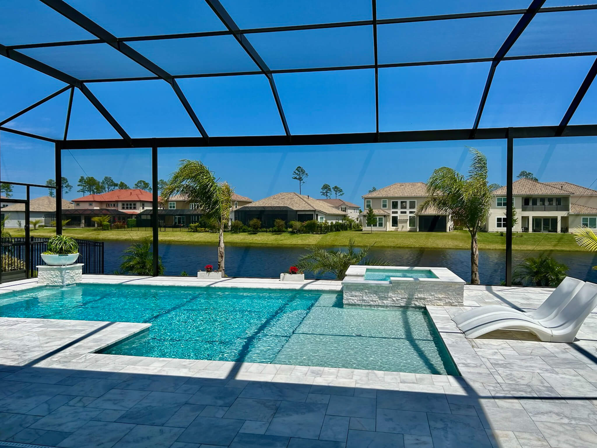 Home A tropical pool in Jacksonville Florida with a UV protective pool screen enclosure made by Screen Enclosures and More.