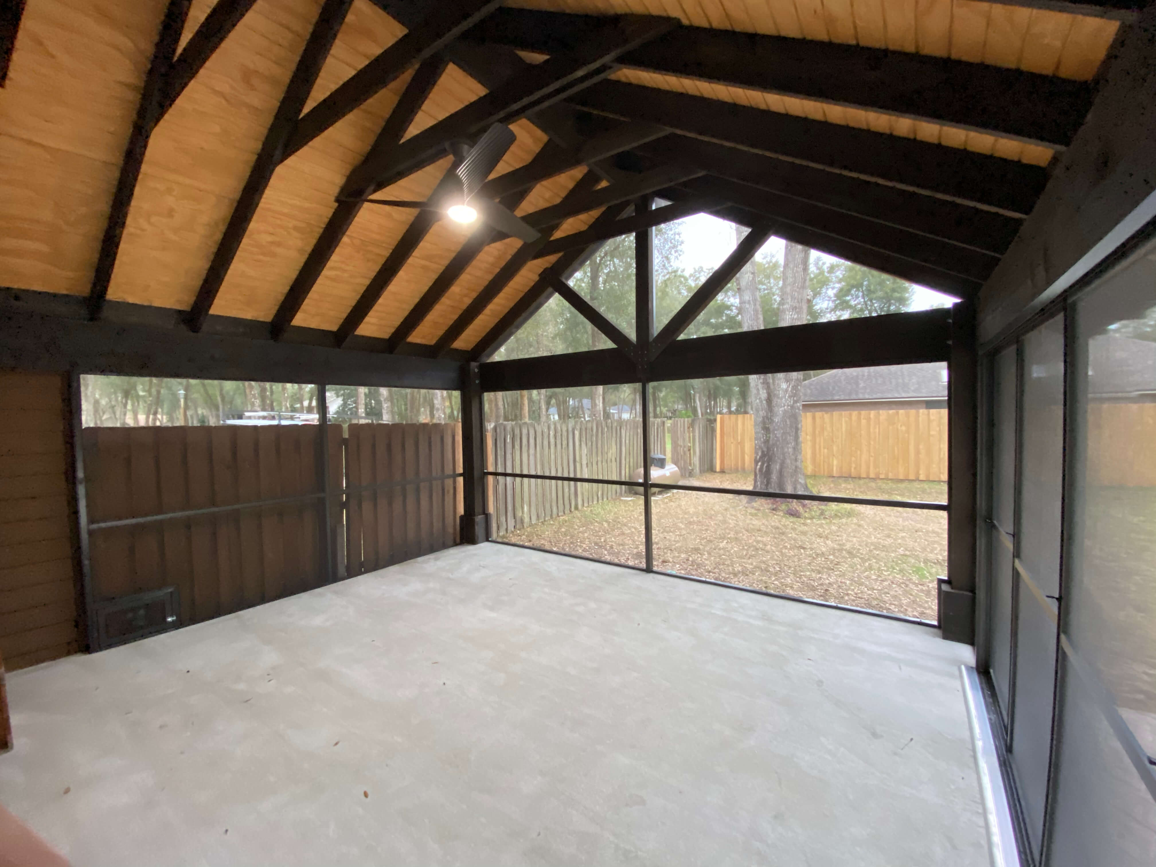 IMG_0898 This beautiful screened-in lanai has a very high roof with exposed beams, electrical, and a ceiling fan with light. Screen Enclosures and More takes pride in the custom projects we build and design for our clients.