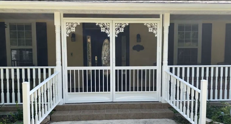 This screen enclosure has custom doors that tie in with the architecture of the home, providing a seamless experience.