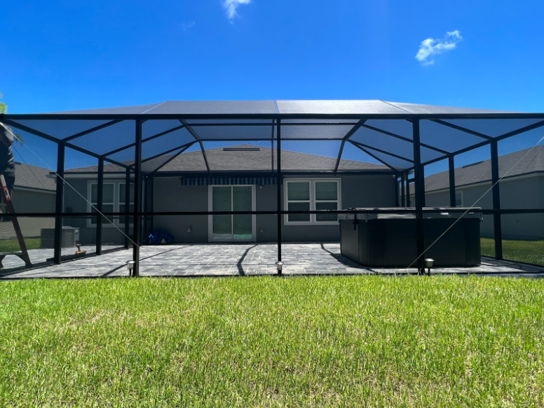 This screen enclosure surrounds an outdoor hot tub so that the owners may enjoy their tub without getting eaten by mosquitoes.