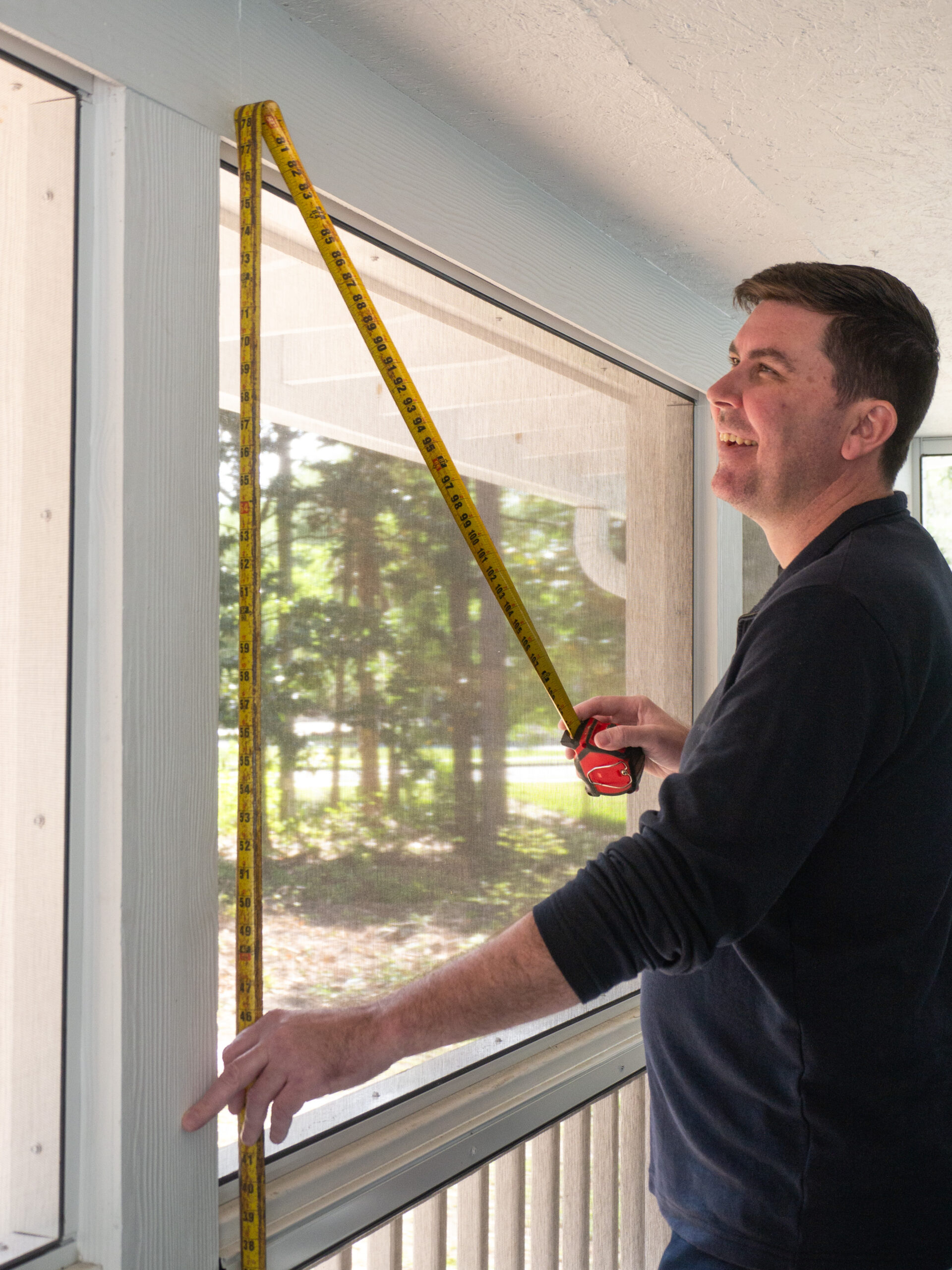 Screen Enclosures and More team measuring for a new custom project.