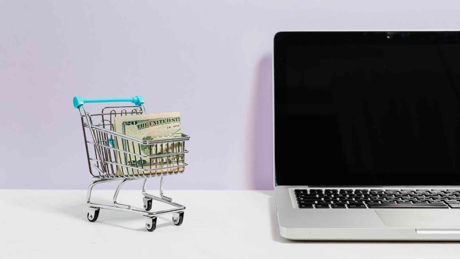 The Top 10 Best Online Shopping Carts For Merchants (And How To Choose The Right One) - Small Shopping Cart Next To Computer