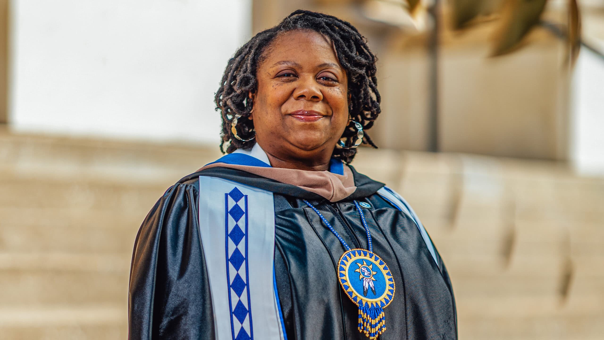 Shanna Douglas smiles in her graduation robes