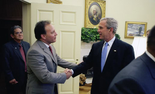 Gary Batton shakes hands with George W. Bush