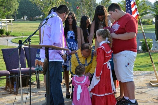 Chief attending a Sunday morning prayer service at the Labor Day festival in Tushkahoma, OK