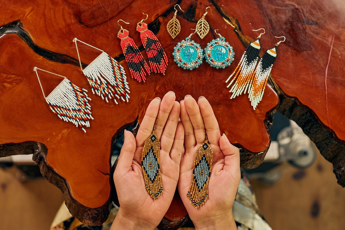 Jula Harjo displays her beaded earrings