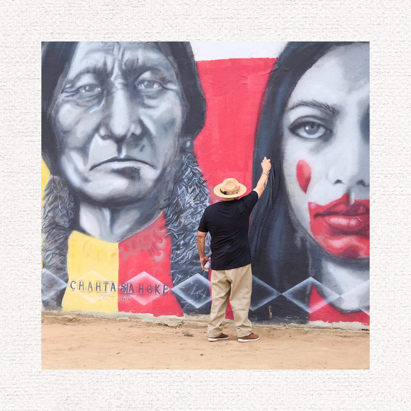 Bobby Von Martin works on a wall mural