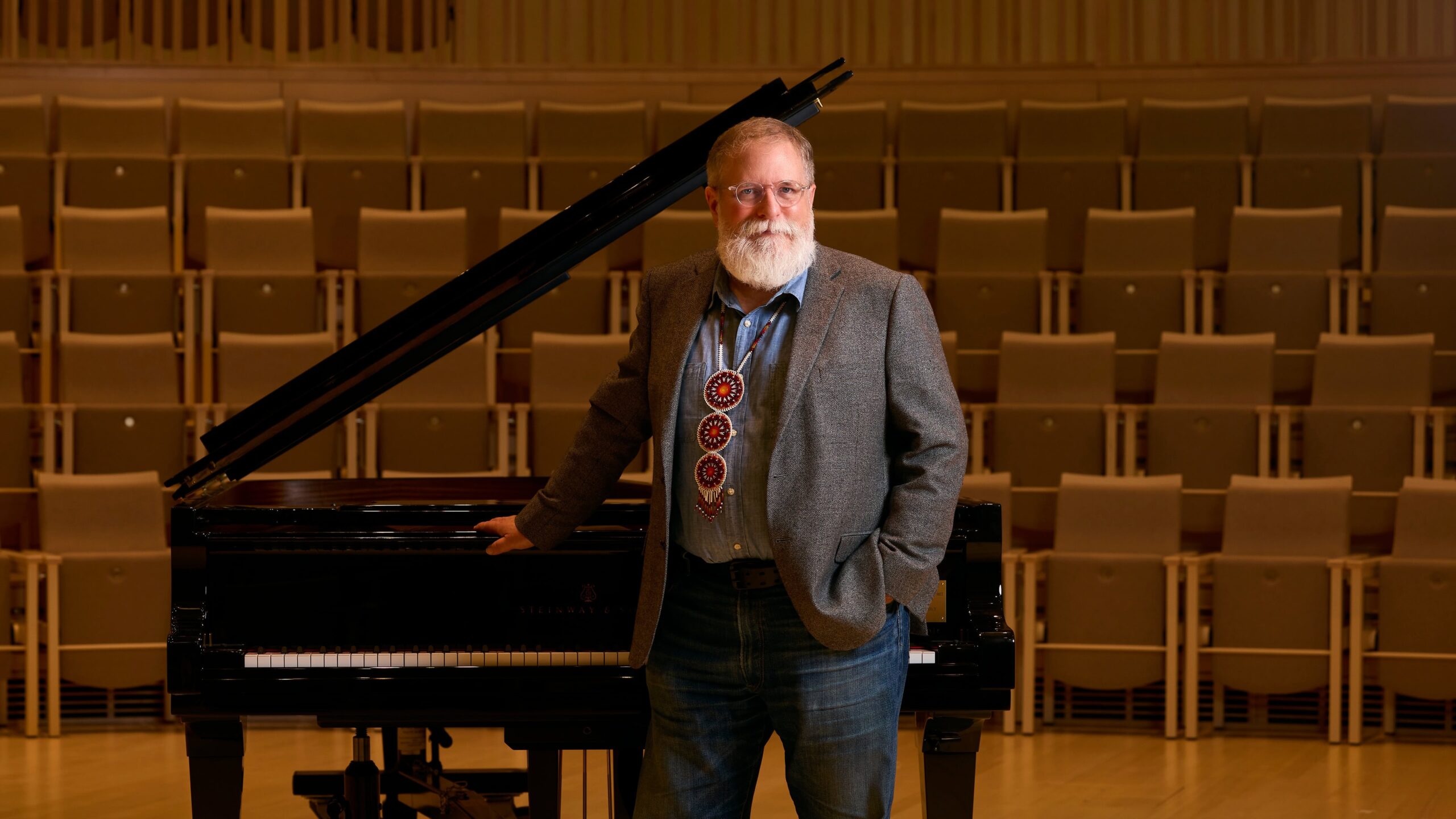 Charles standing in front of his piano.