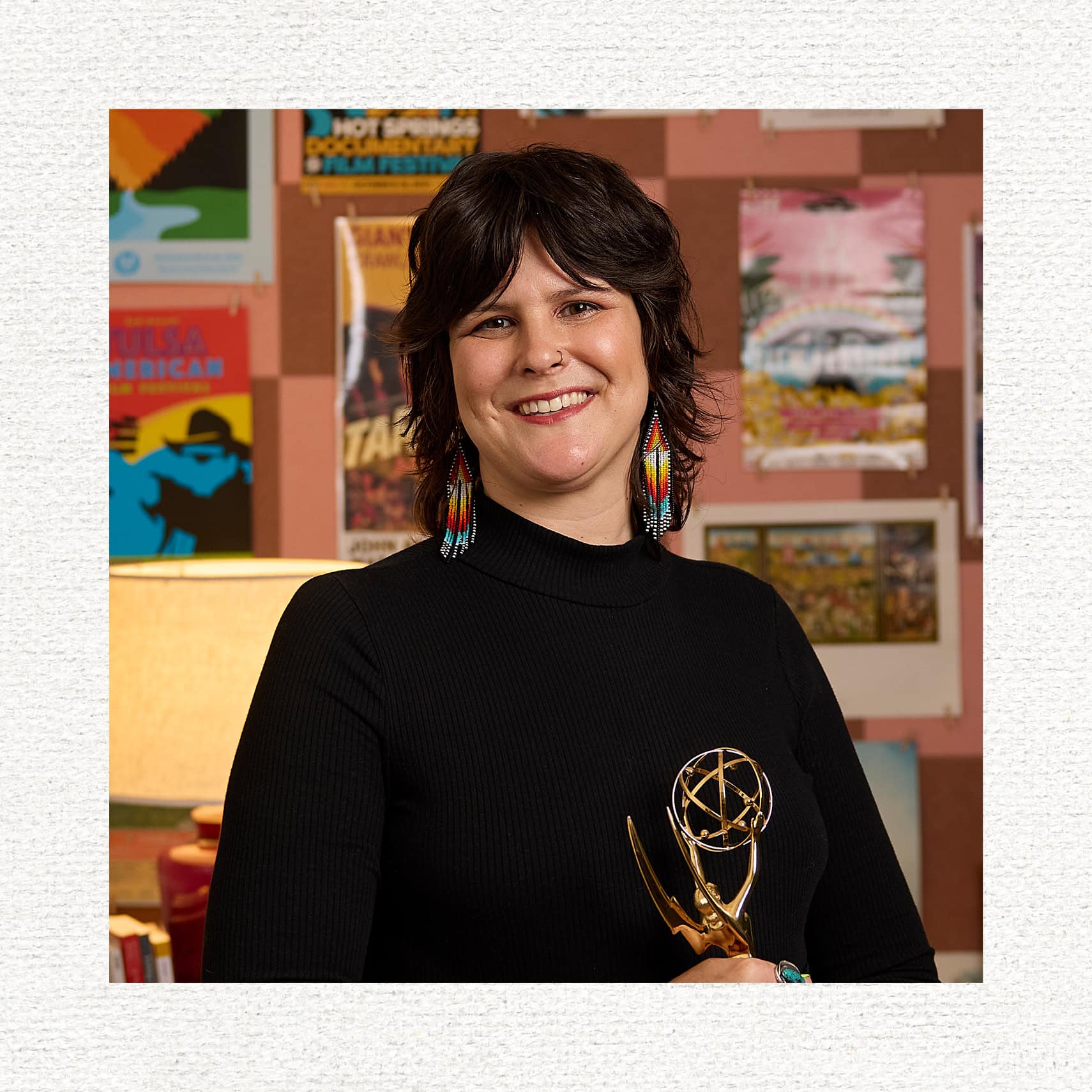 Collen Thurston smiling and holding her award.