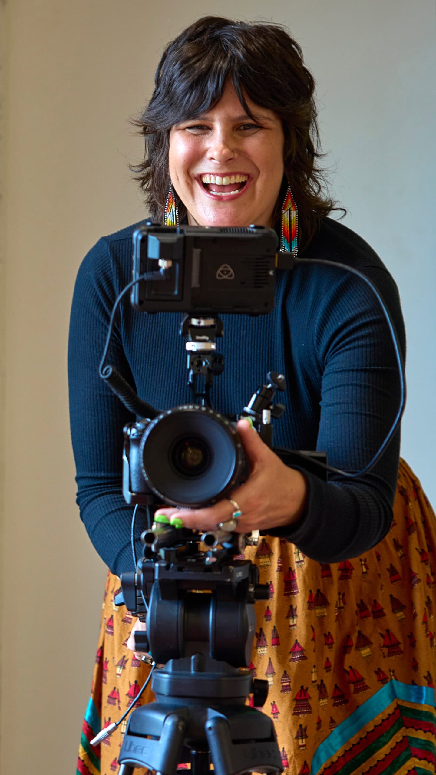 Colleen Thurston shooting film and smiling.