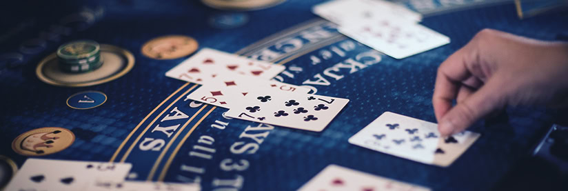 Blackjack gaming table showing cards and chips for card game players.