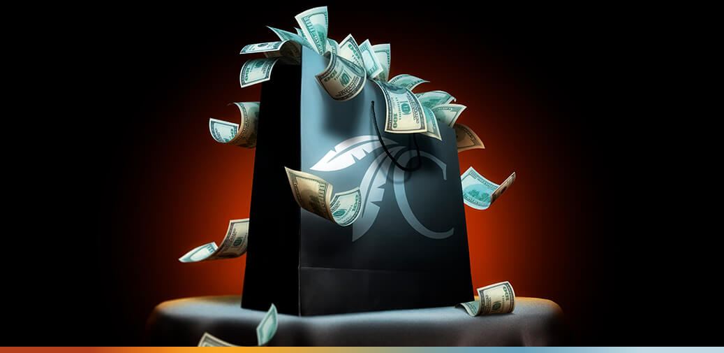 Black shopping bag filled with money