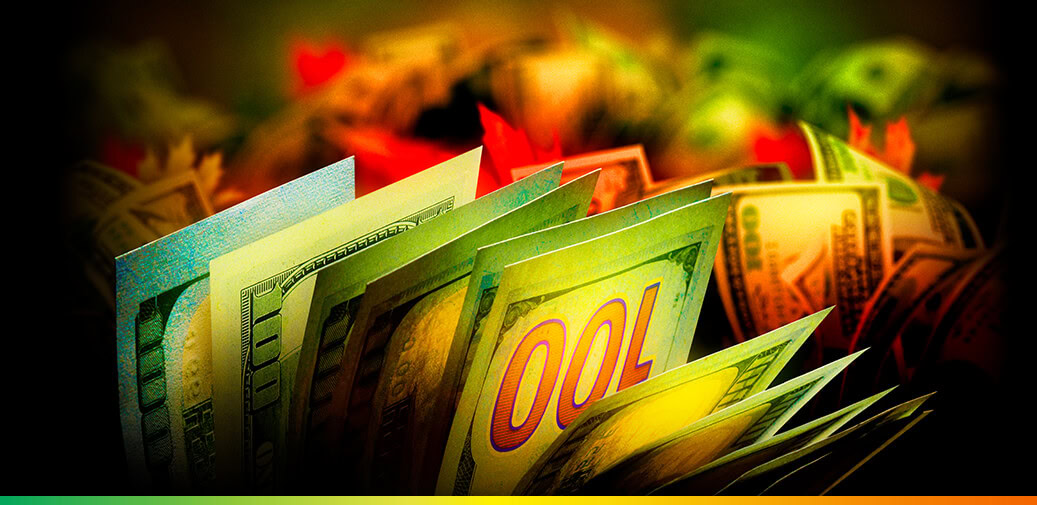 $100 bills with pumpkins in the background.
