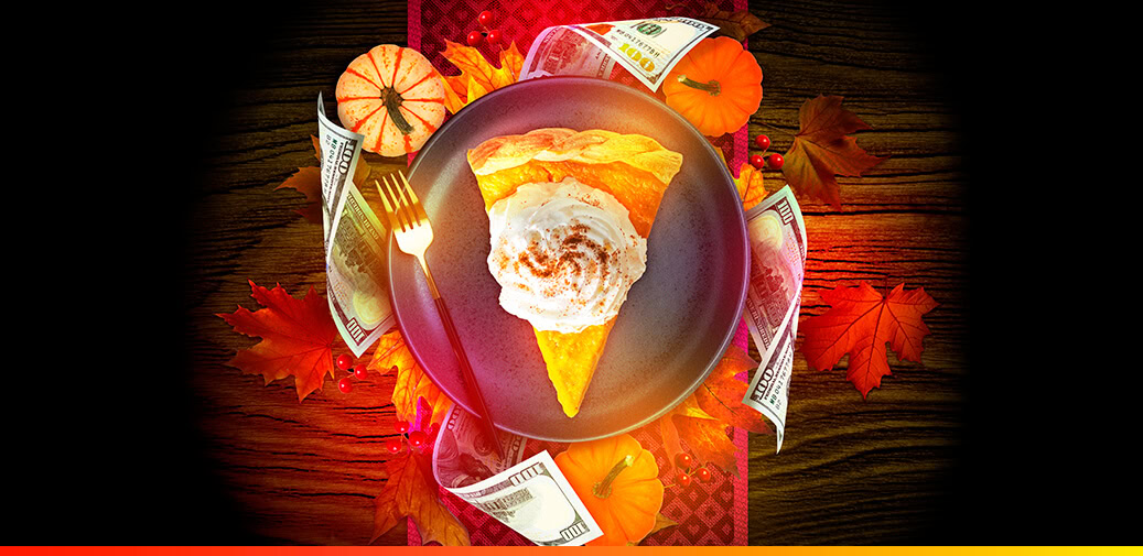 Pie slice surrounded by cash and fall decorations.