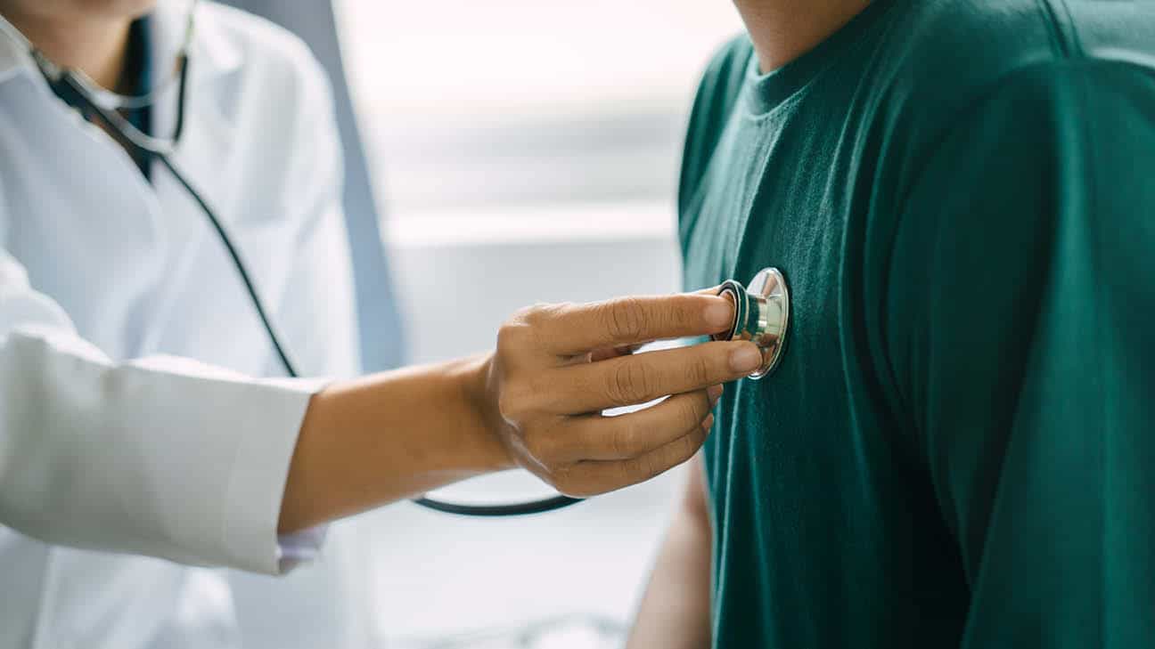 A doctor listening to a patient's heart.