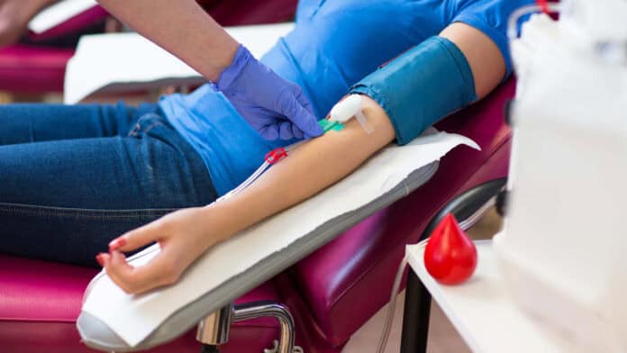 A person getting their arm prepared to give blood.