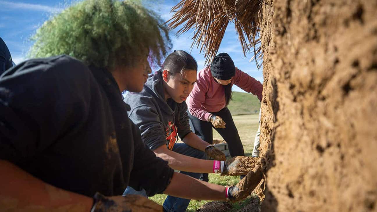 Hands-on experience to "mud" a traditional Choctaw winter home