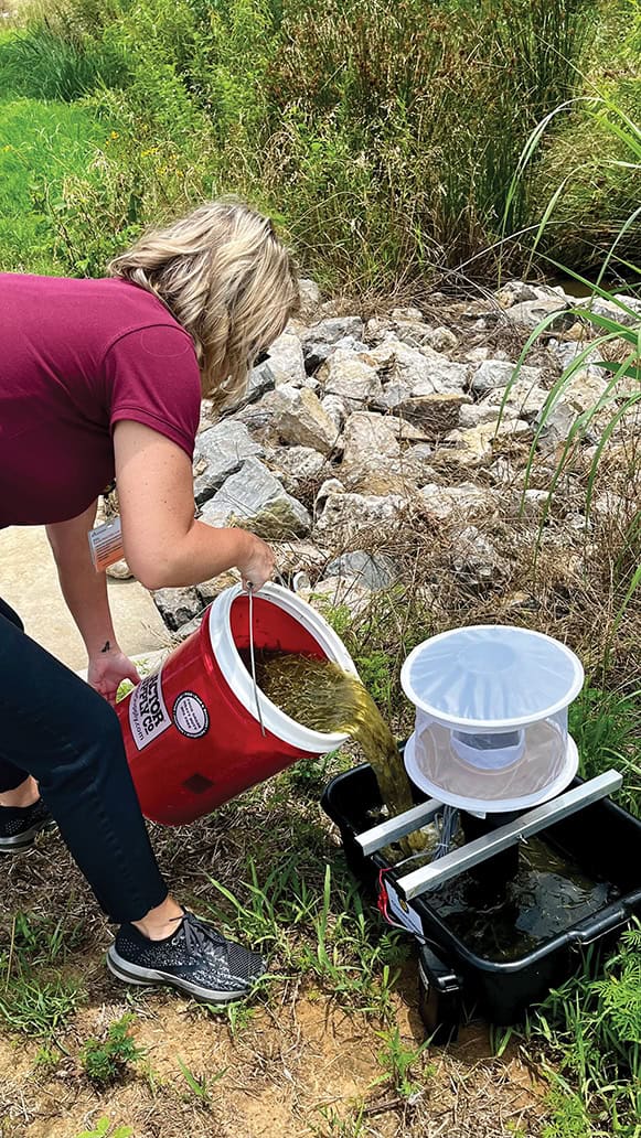 Rikki LaRoche prepares a mosquito surveillance trap