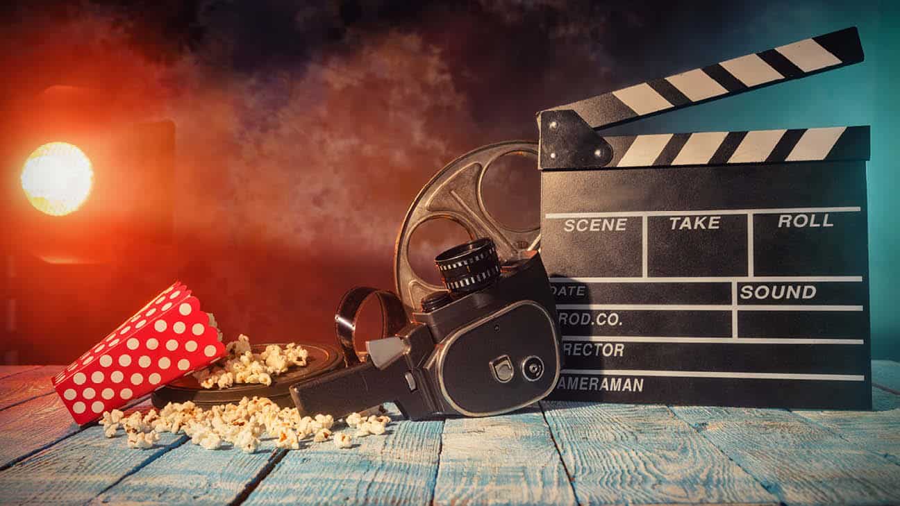 Table with camera, popcorn and clapperboard