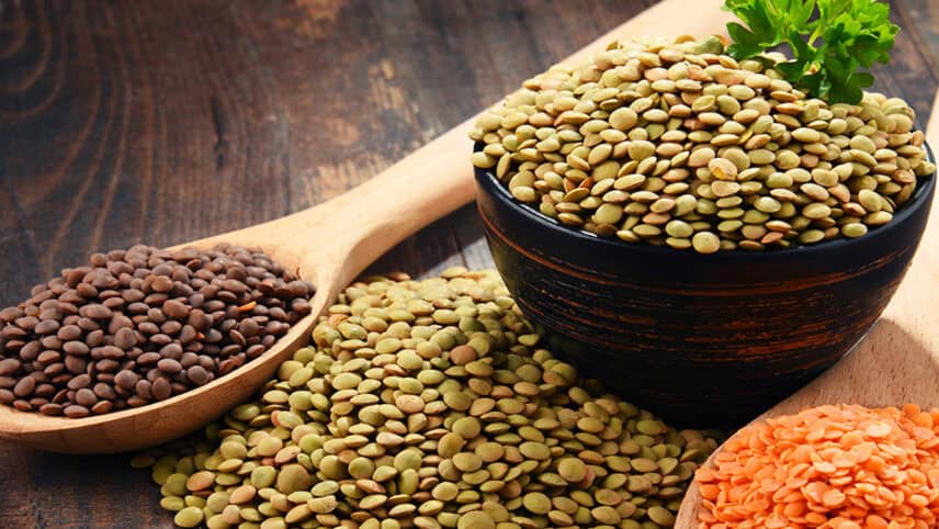 Several different types of lentils on a table.