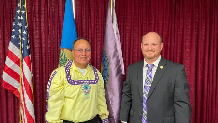 Chief Batton and Mayor Few stand in front of the newly posted Choctaw Flag