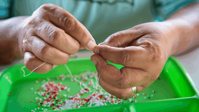 Woman beading jewelry