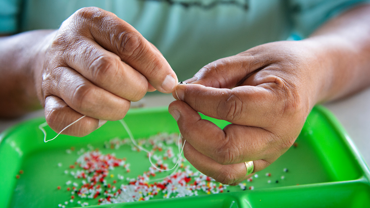 Woman beading jewelry