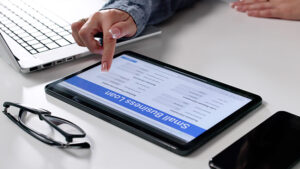 Woman Filling Out Small Business Loan Application