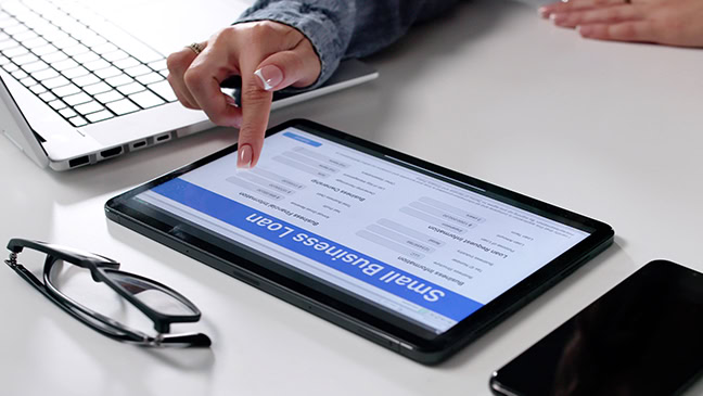 Woman Filling Out Small Business Loan Application