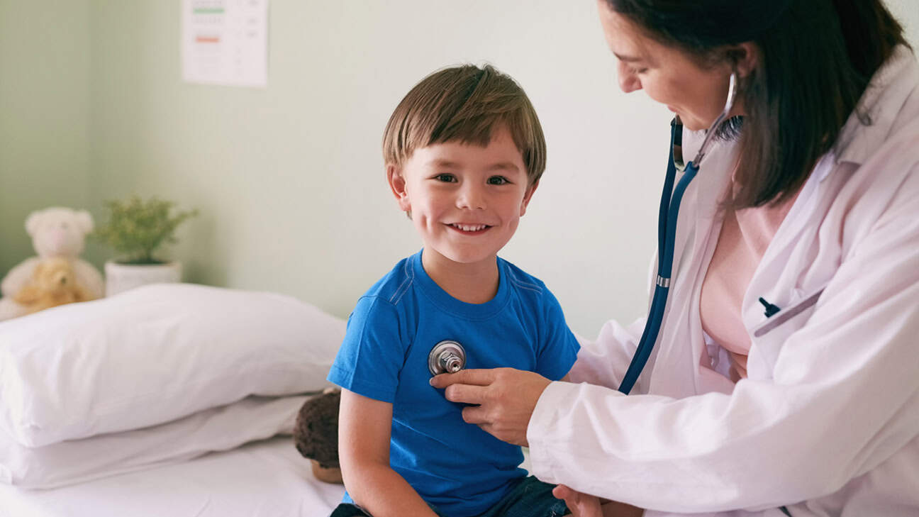 Doctor checking a child's lungs with a stethoscope.