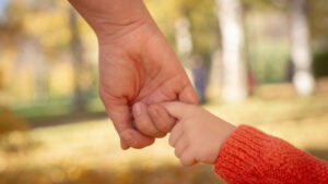 A child holding an adult's hand