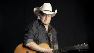 Mark Chesnutt holding his guitar.