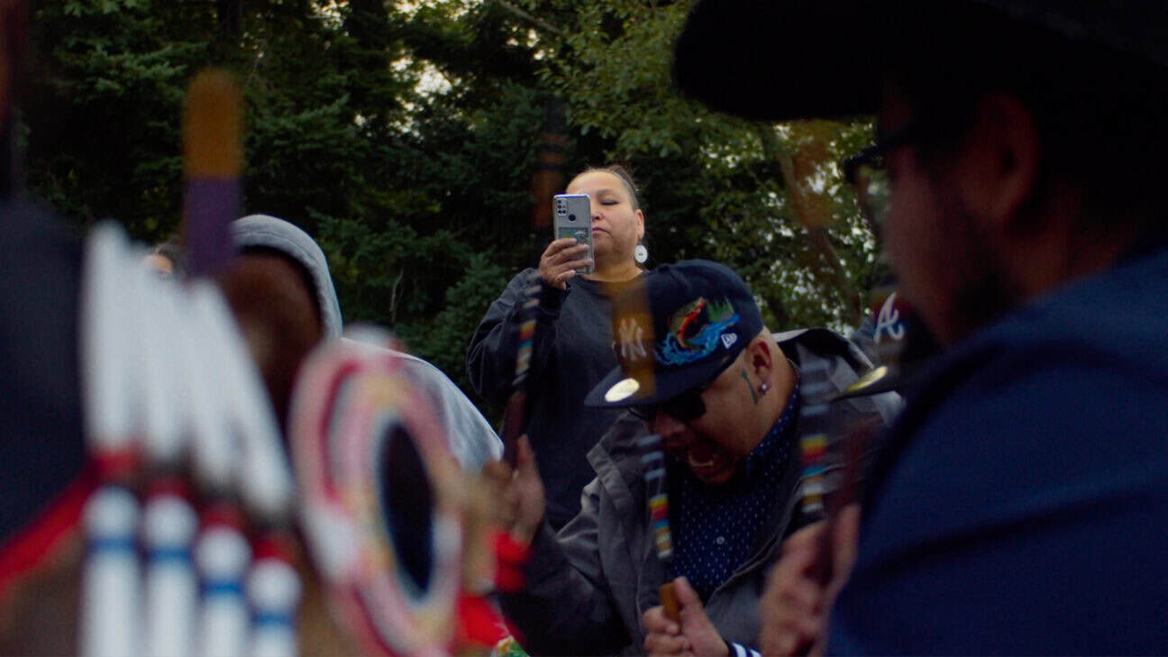 A woman recording a Powwow.