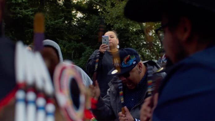 A woman recording a Powwow.