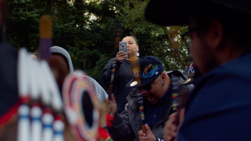 A woman recording a Powwow.