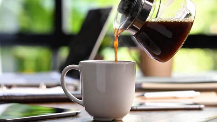 Pouring coffee into a mug.