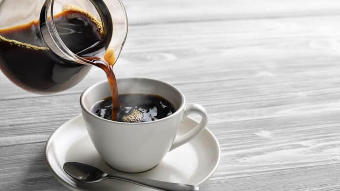 Pouring coffee into a mug.