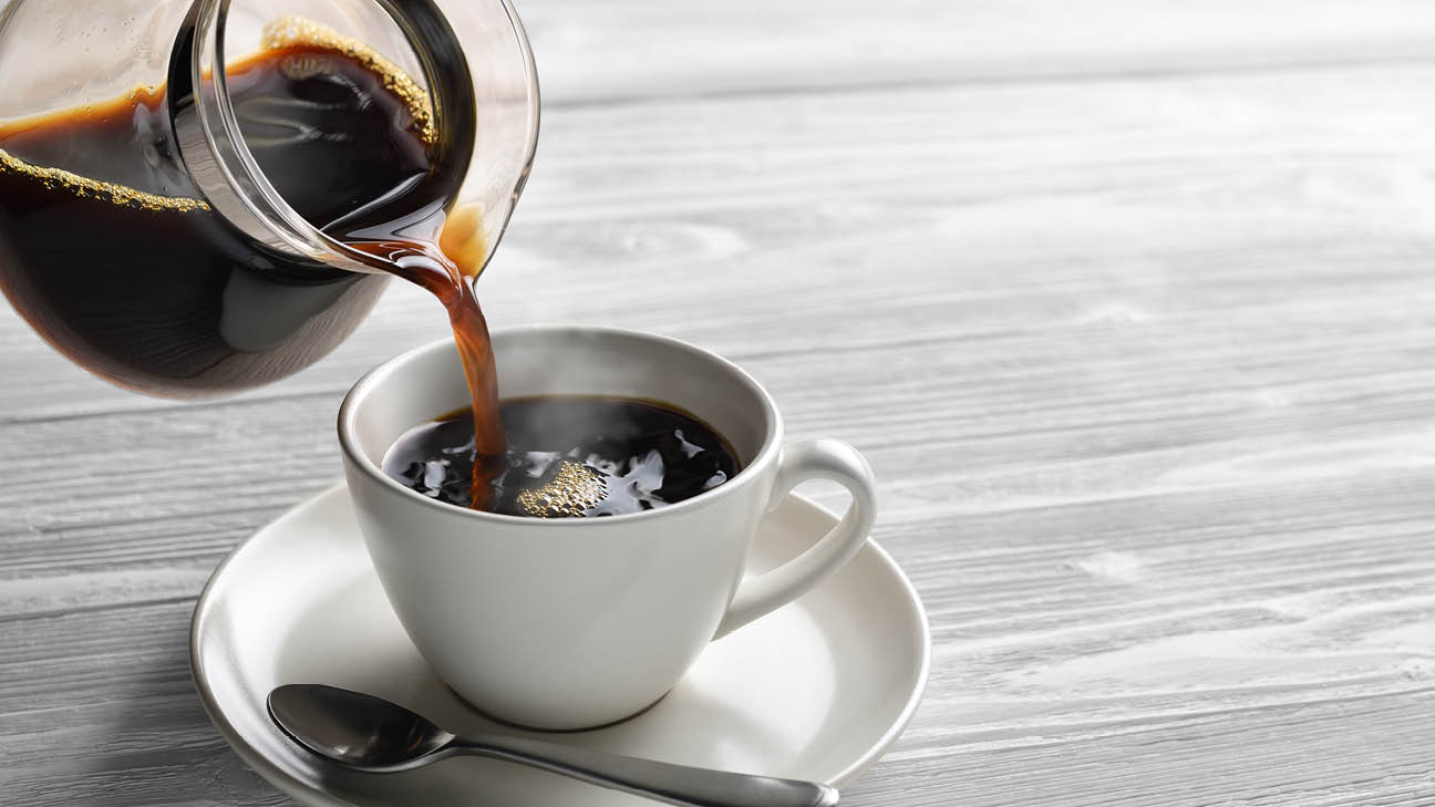 Pouring coffee into a mug.